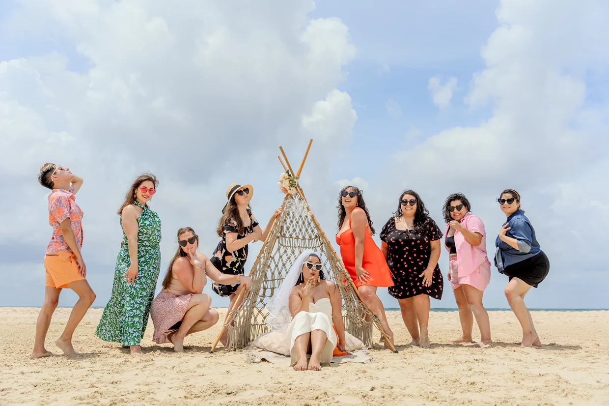 Bachelorette group posing with macramé teepee