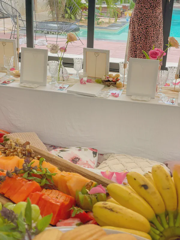 Fresh tropical fruit display and art supplies for Caribbean painting session