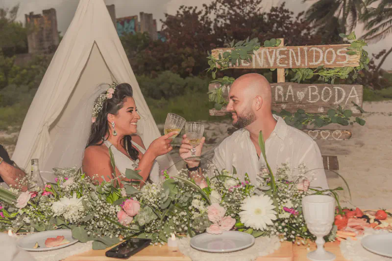 Intimate beach reception with rustic decor and personalized details