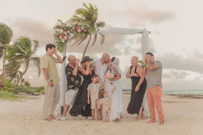 Fun candid moment during beach wedding with family