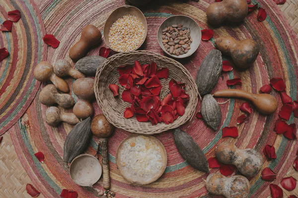Traditional Mayan ceremony offerings including cacao, corn, and sacred objects arranged on colorful woven mat for authentic wedding ritual in Riviera Maya